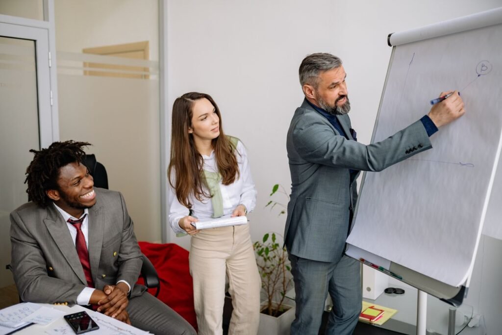 Diverse team of professionals in a training session around a flip chart